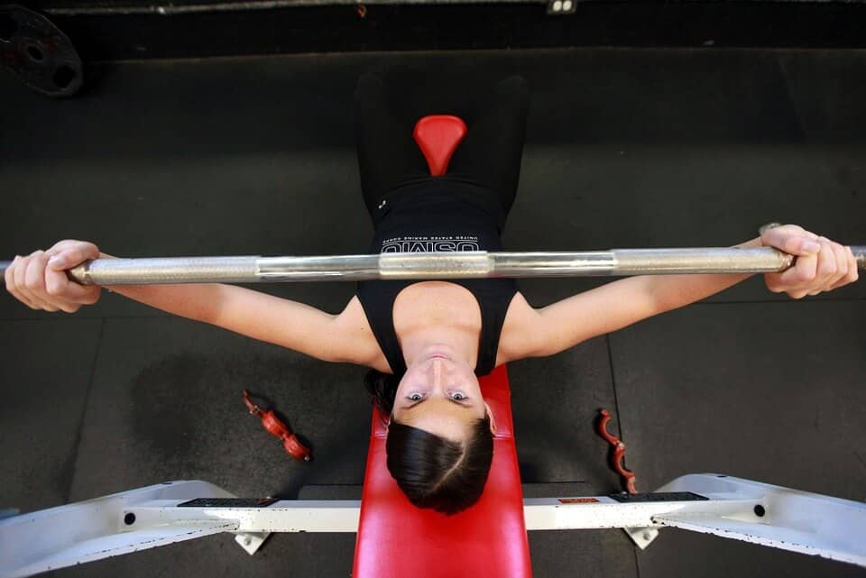 View from above of women starting a flat bench press set